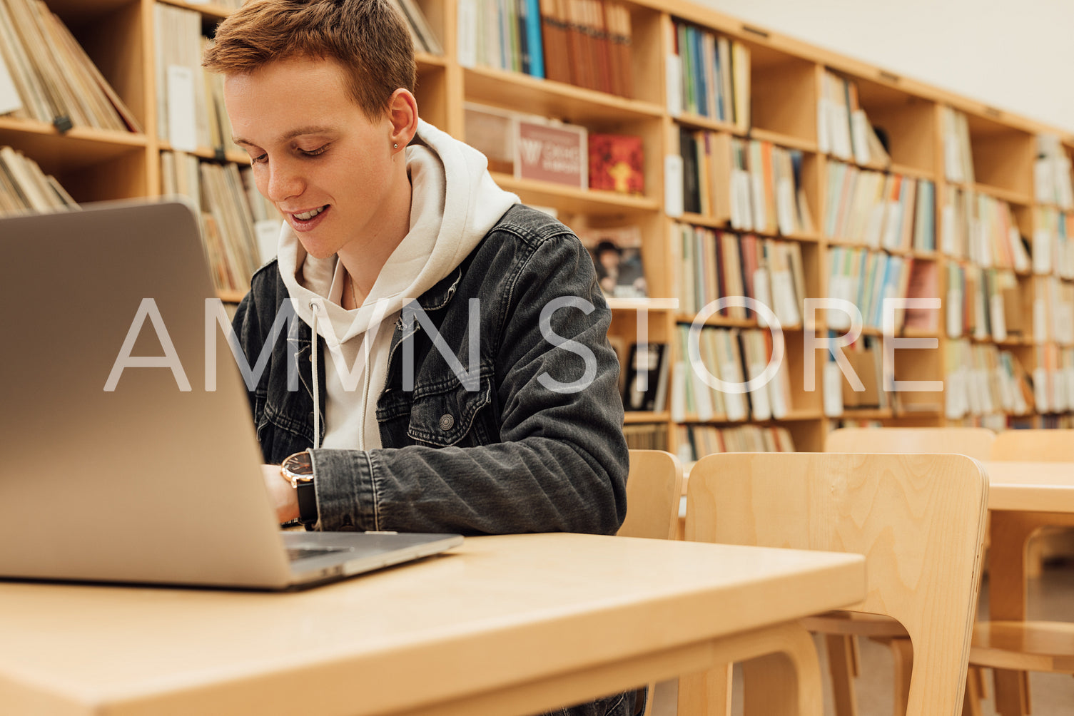 Smiling student preparing for exams in college library