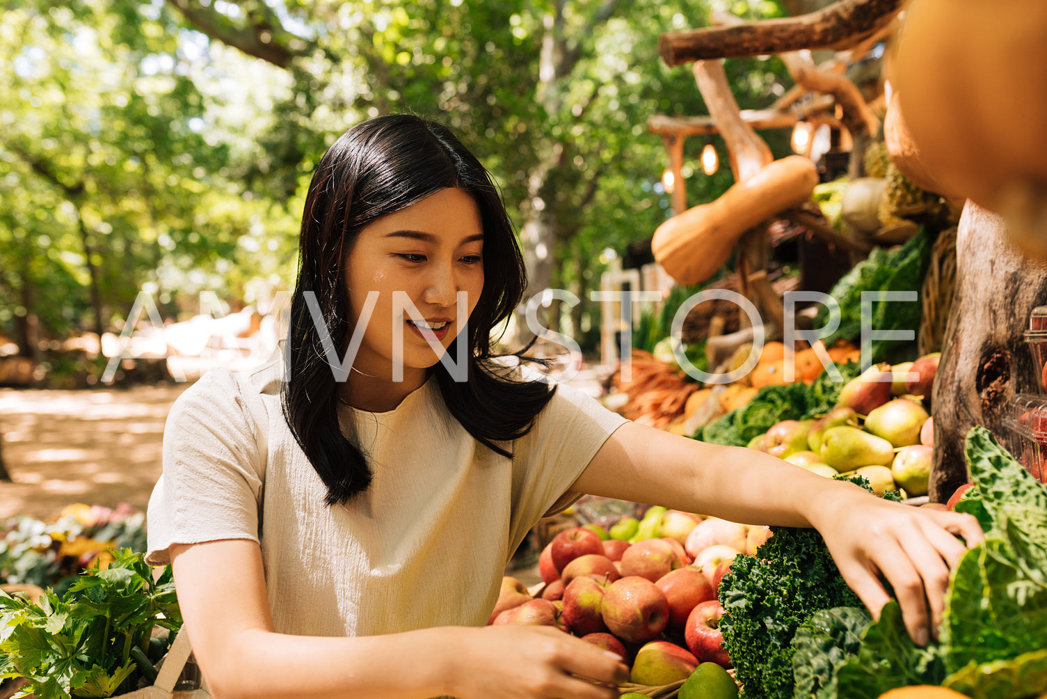 Young woman choosing lettuce on an outdoor market