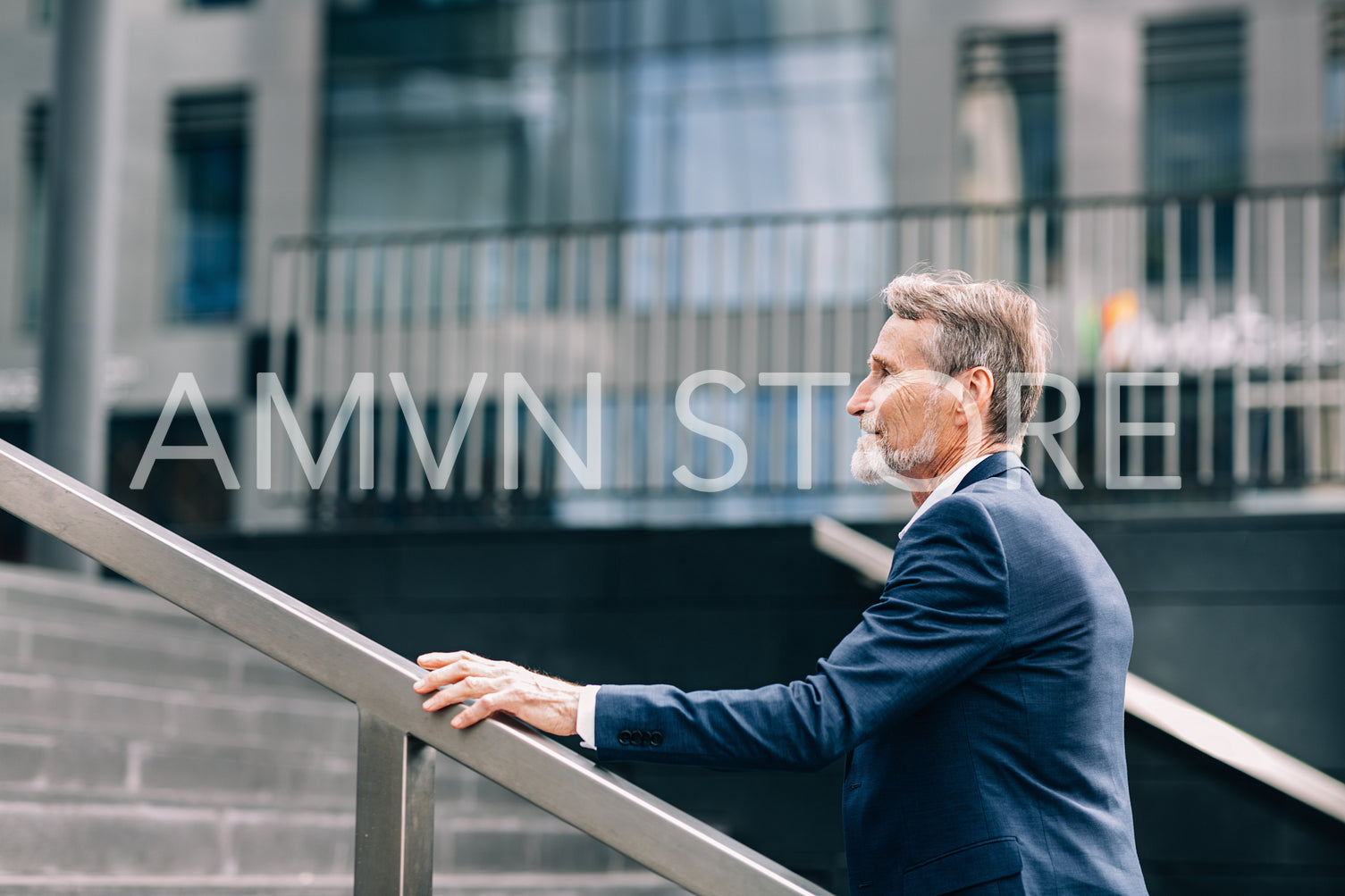 Side view of senior investor walking on stairs outside the office building in the city	