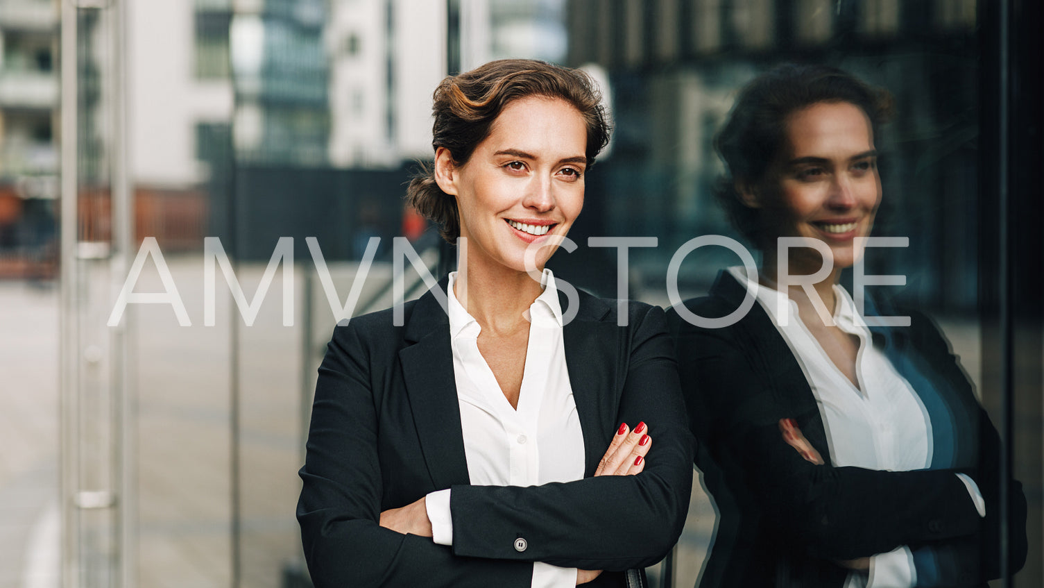 Young entrepreneur at office building. Confident woman standing outdoors and looking away.	