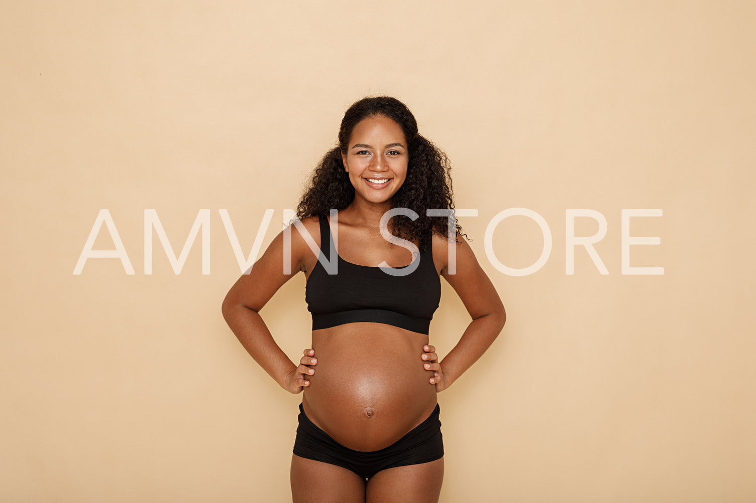 Portrait of a happy pregnant woman in studio	