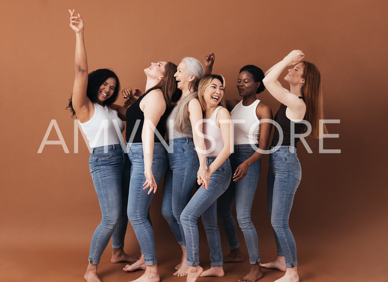 Six diverse women laughing together. Females with different body types having fun while standing against a brown background.