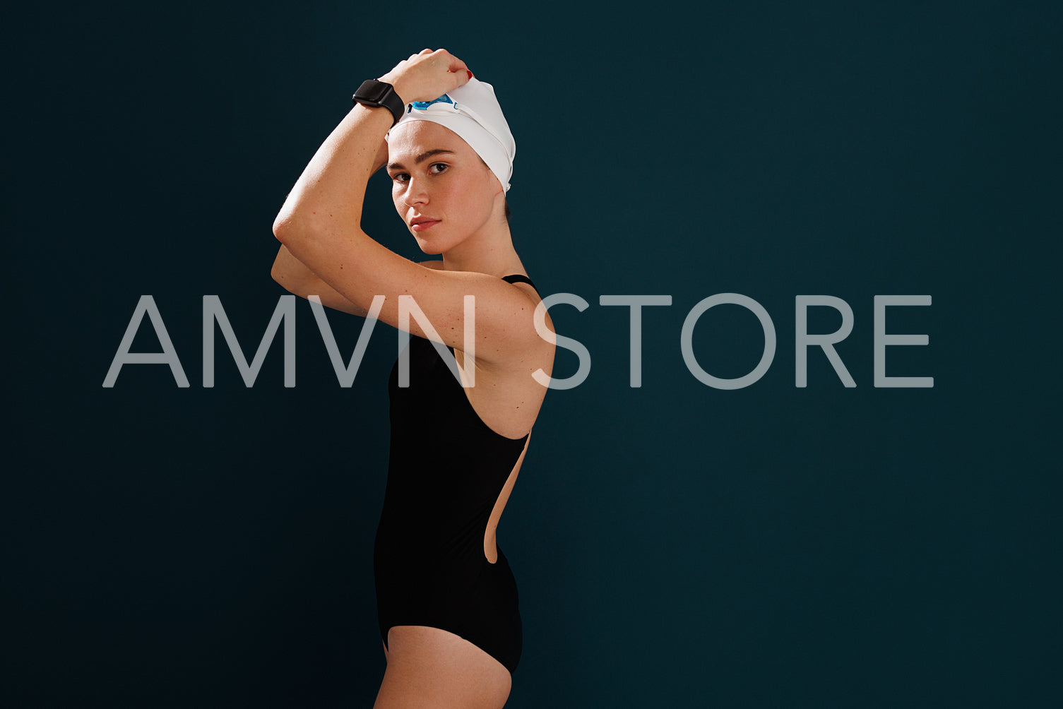 Portrait of a professional woman swimmer adjusting her swimming cap