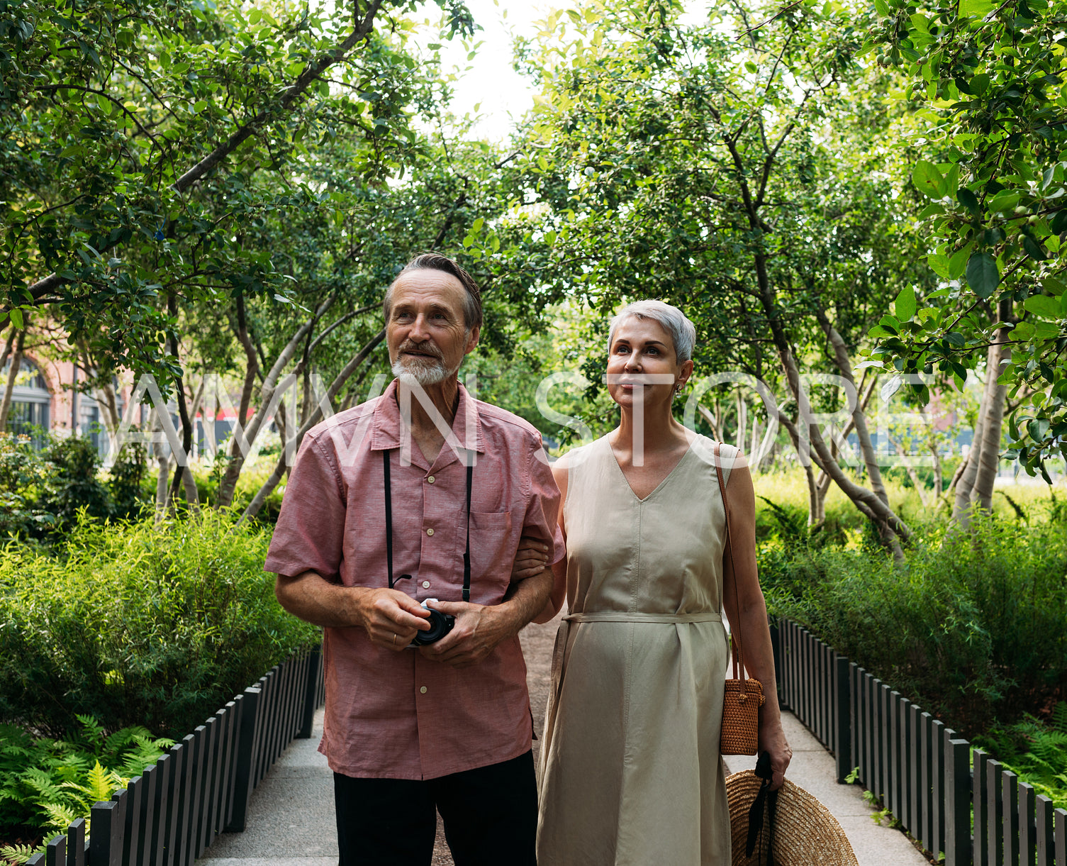 Aged husband and wife walking together in the park