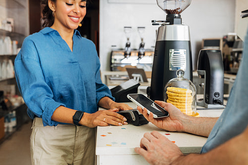 Customer paying bill through a smartphone using NFC technology