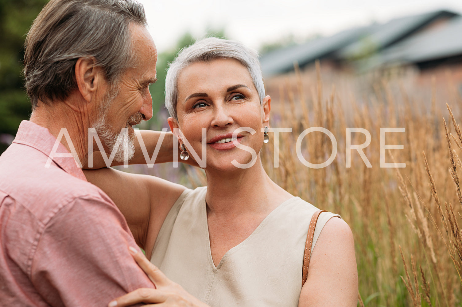 Two senior people standing together in the field outdoors