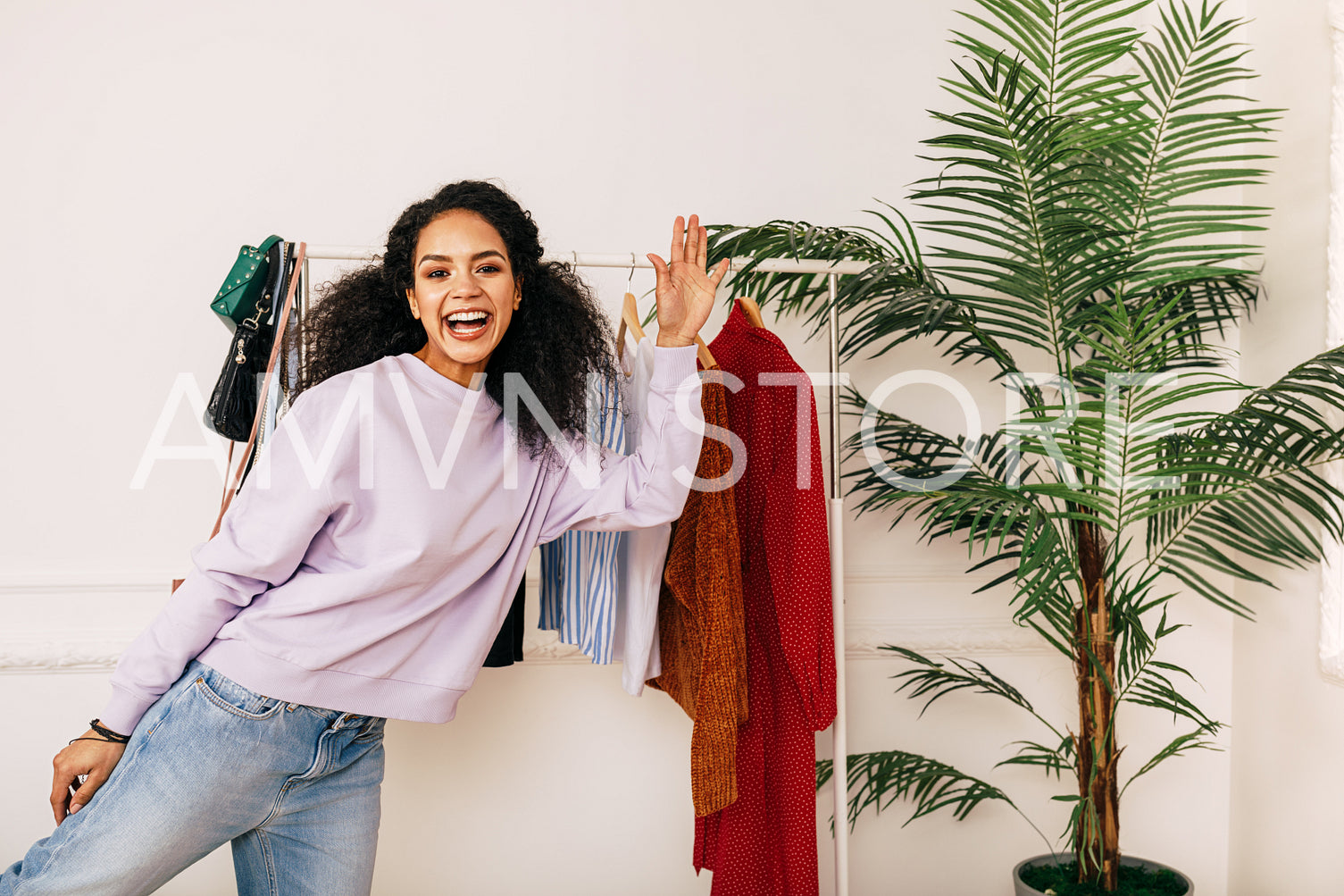 Happy stylist posing in studio. Young blogger greetings her audience.	