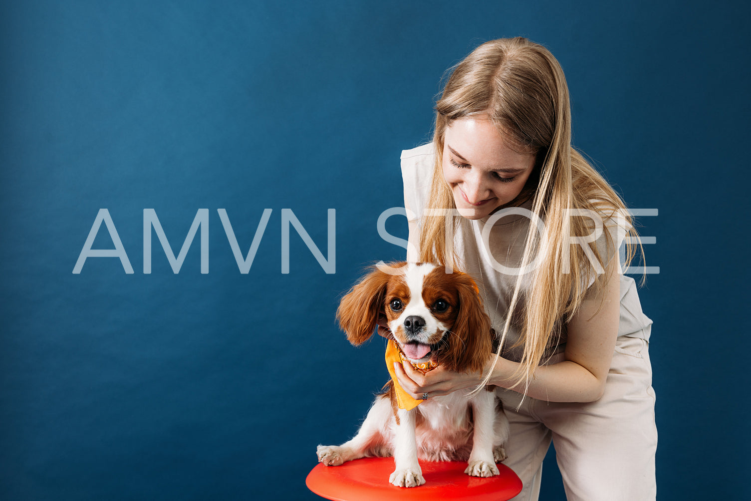 Studio portrait of a young woman with her little dog