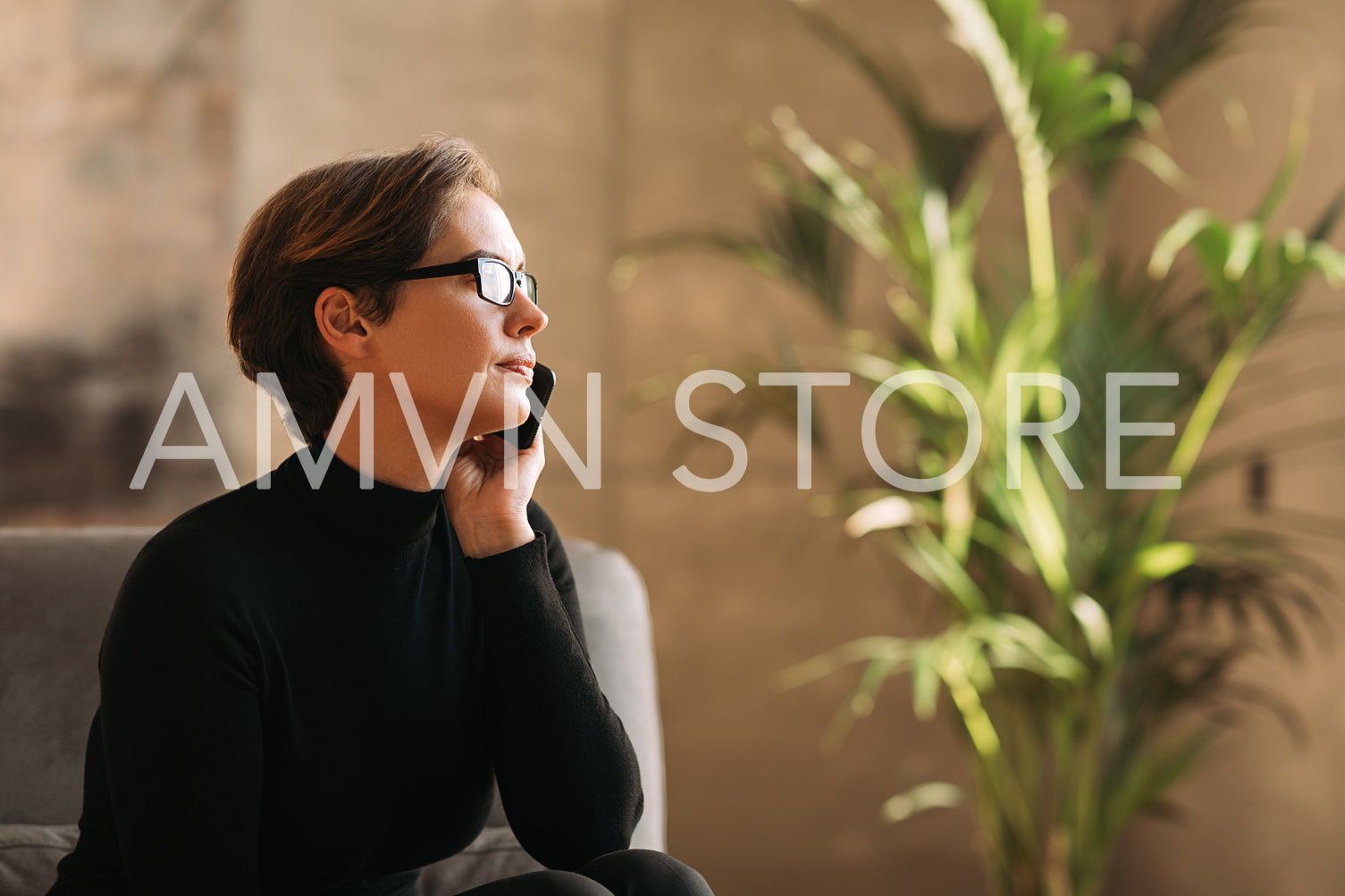 Side view of a businesswoman with short hair talking on a mobile phone