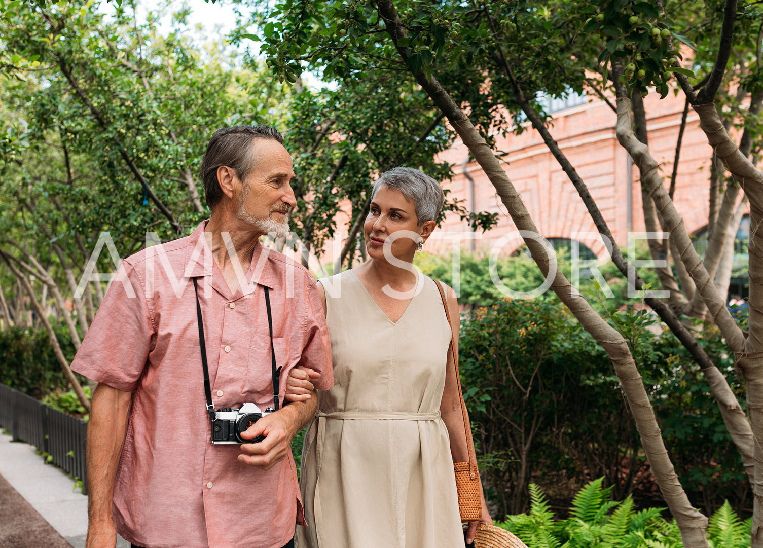 Senior couple walking in the park together. Aged tourists walking outdoors.