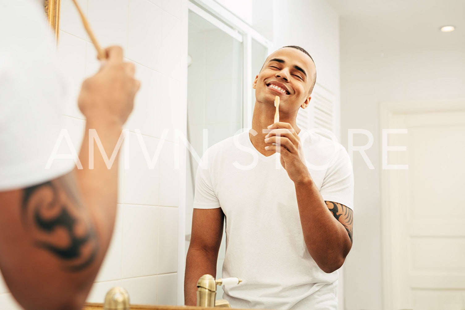 Happy man with bamboo brush in bathroom	