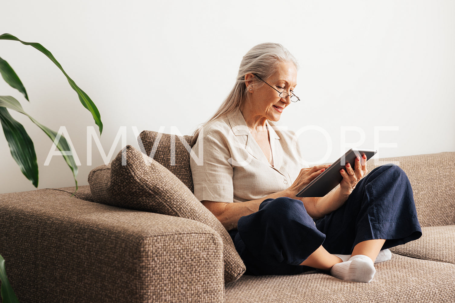 Aged female sitting on a couch