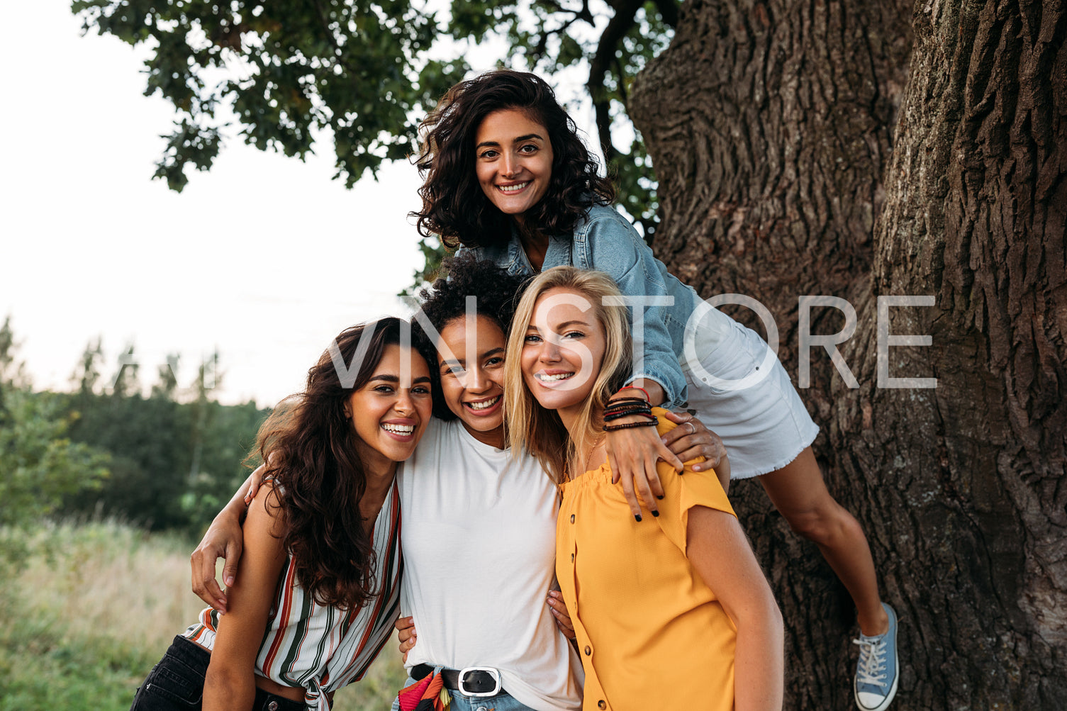 Young beautiful women looking at the camera. Group of females spending time out of town.