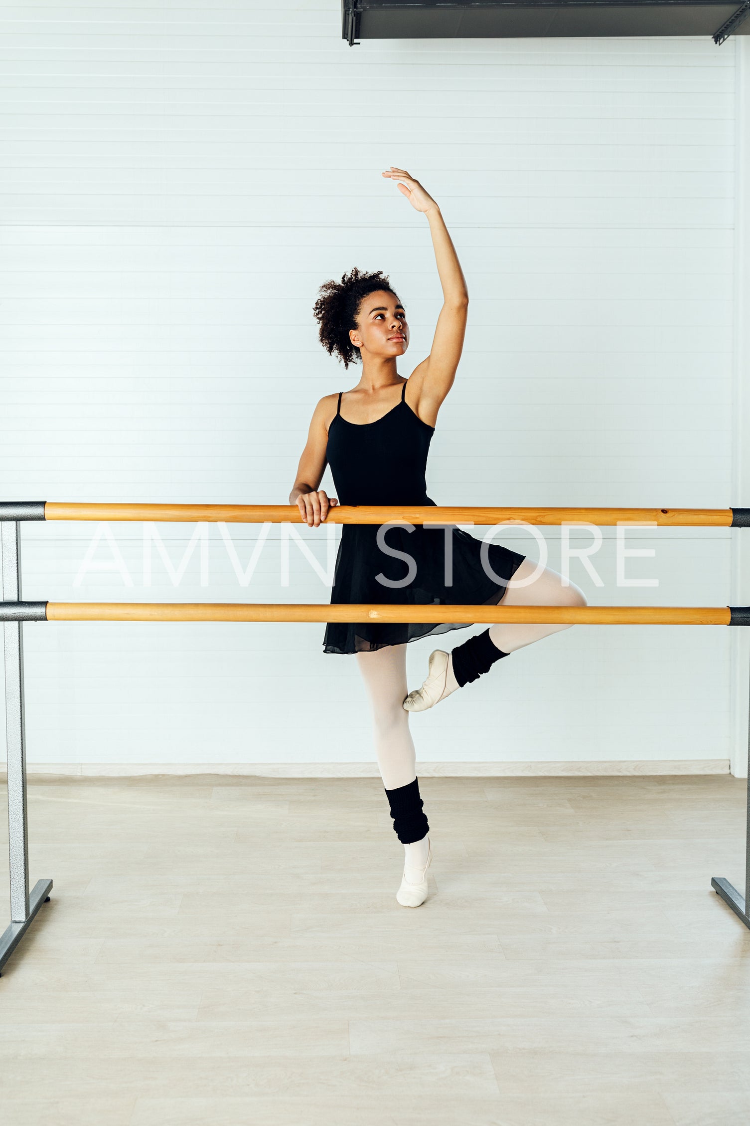 African American ballet dancer practicing moves in studio	