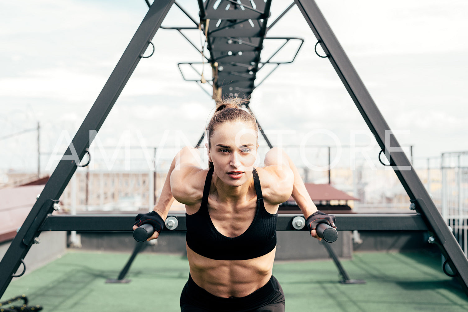 Fitness woman doing triceps dip using power rack on a terrace	
