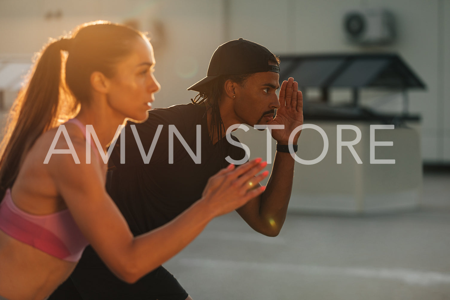 Fitness couple preparing to run at sunset on rooftop