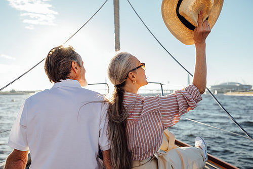 Relaxed mature couple sitting on yacht