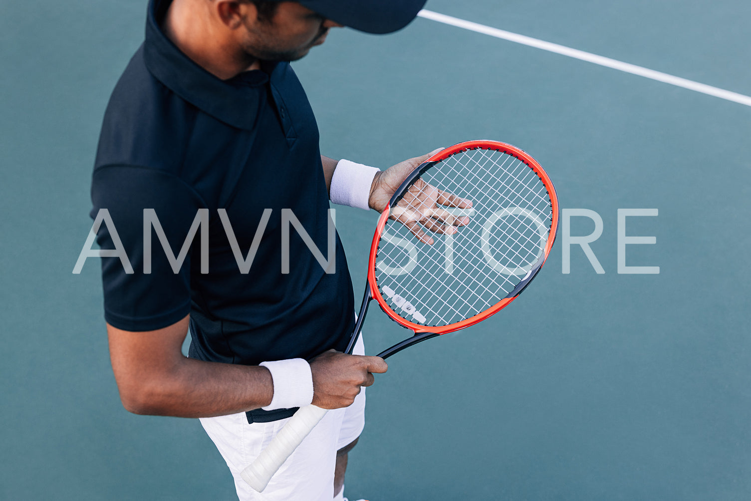 High angle of an unrecognizable male adjusting his tennis racket