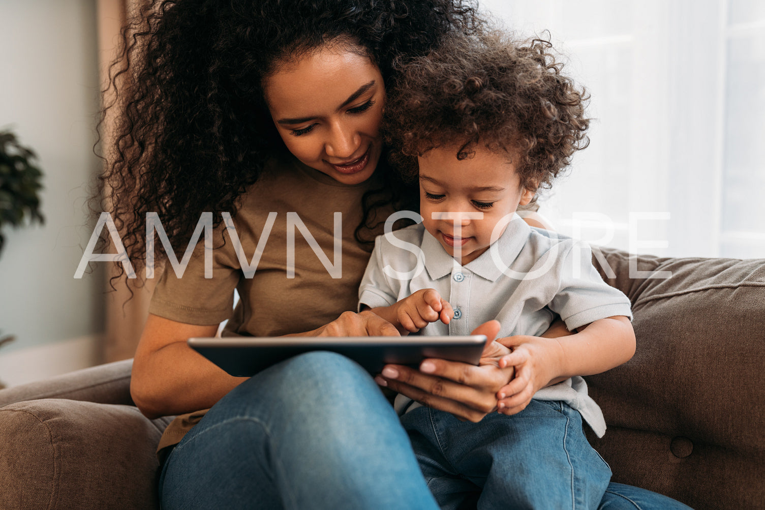 Mother and son using a digital tablet at home