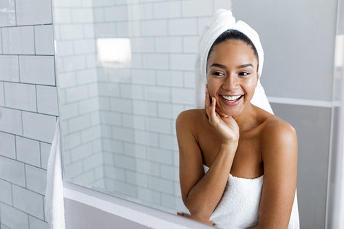 Shot of a beautiful young woman with a towel wrapped around her hair