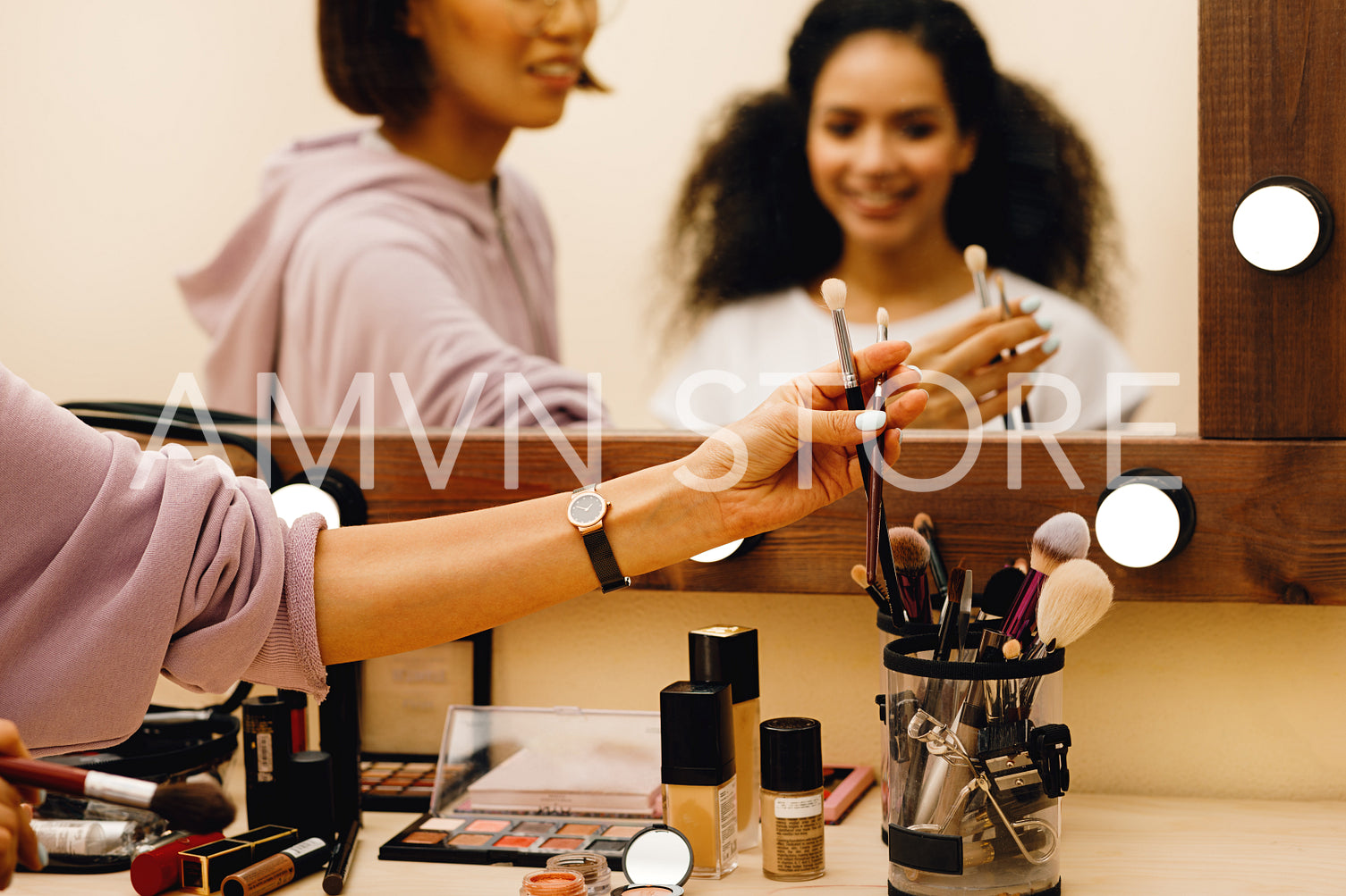 Hand of makeup artist picking up a brush	
