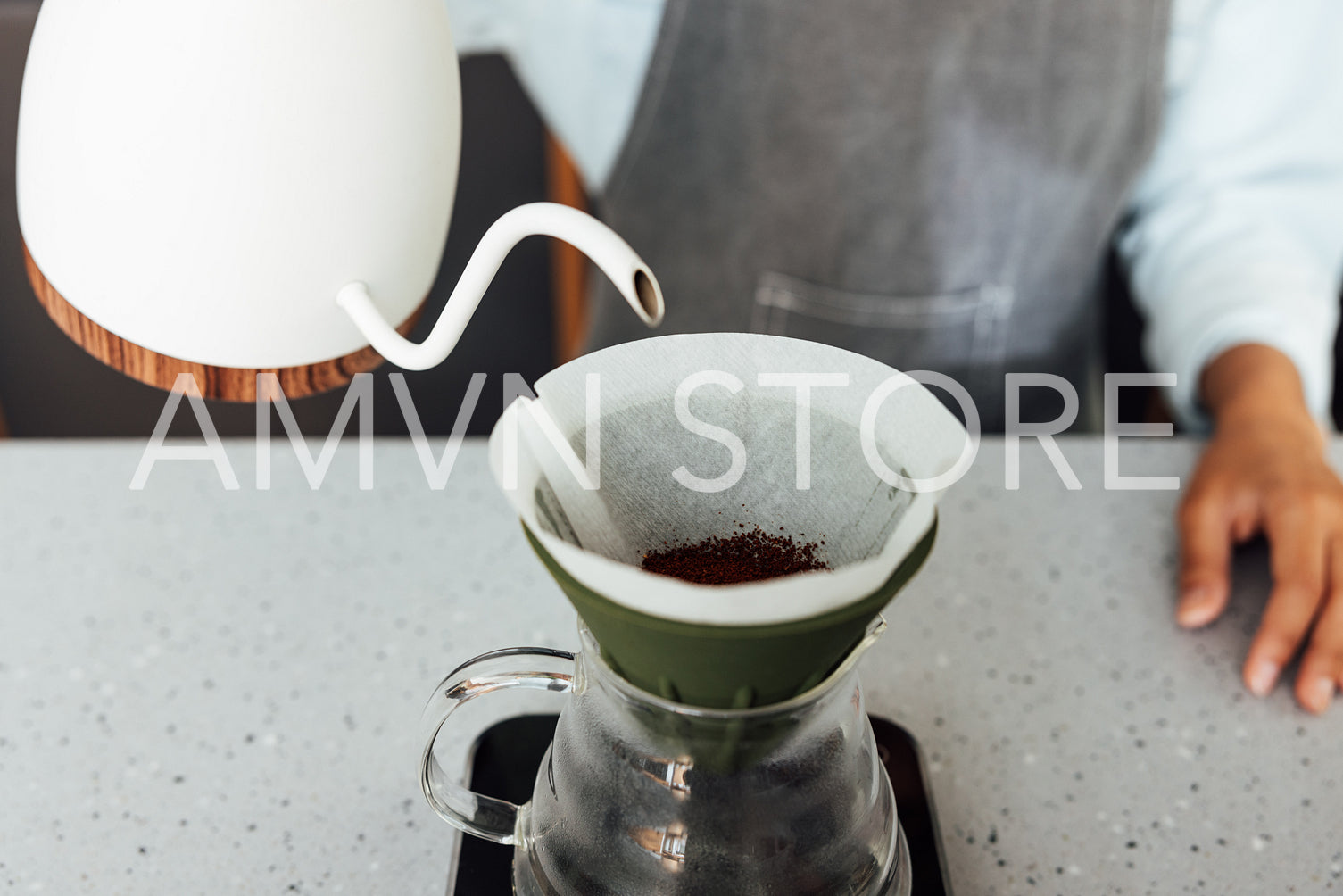 Close-up of an unrecognizable barista brewing coffee with a filter. Process of a gravity-based method of brewing coffee.