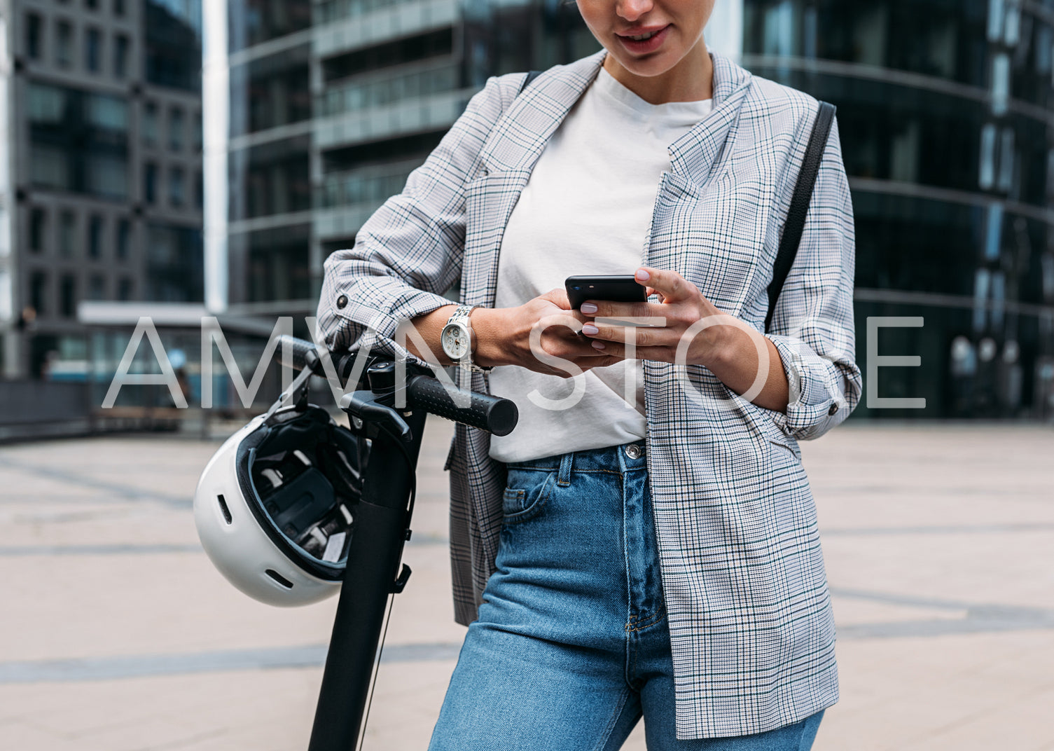 Cropped shot of businesswoman leaning on handlebar of electric scooter using an app for rent