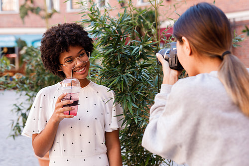 Photographer collaborating with a blogger. Two women creating content for social media.