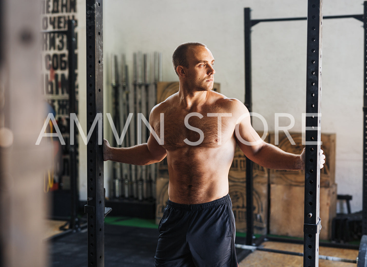 Shot of a muscular athlete standing in sport club, resting during workout