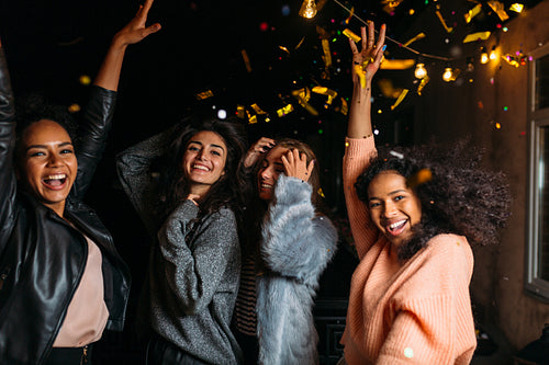 Group of young women hanging out together, dancing outdoors