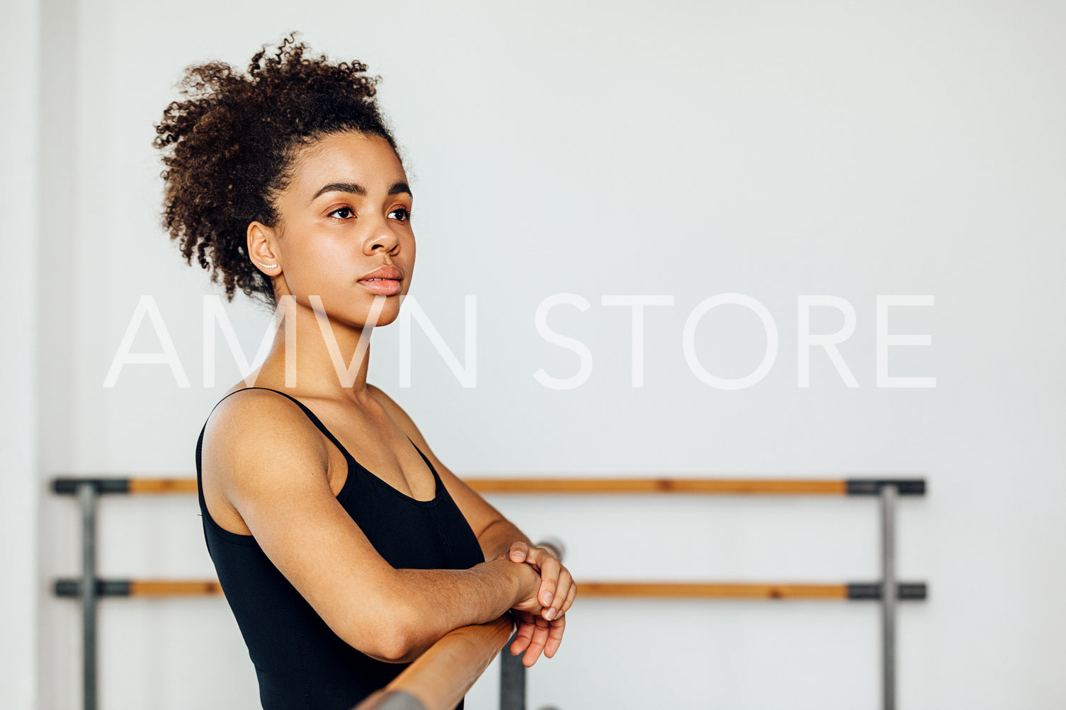 Portrait of a professional ballet dancer looking away while standing in a studio	