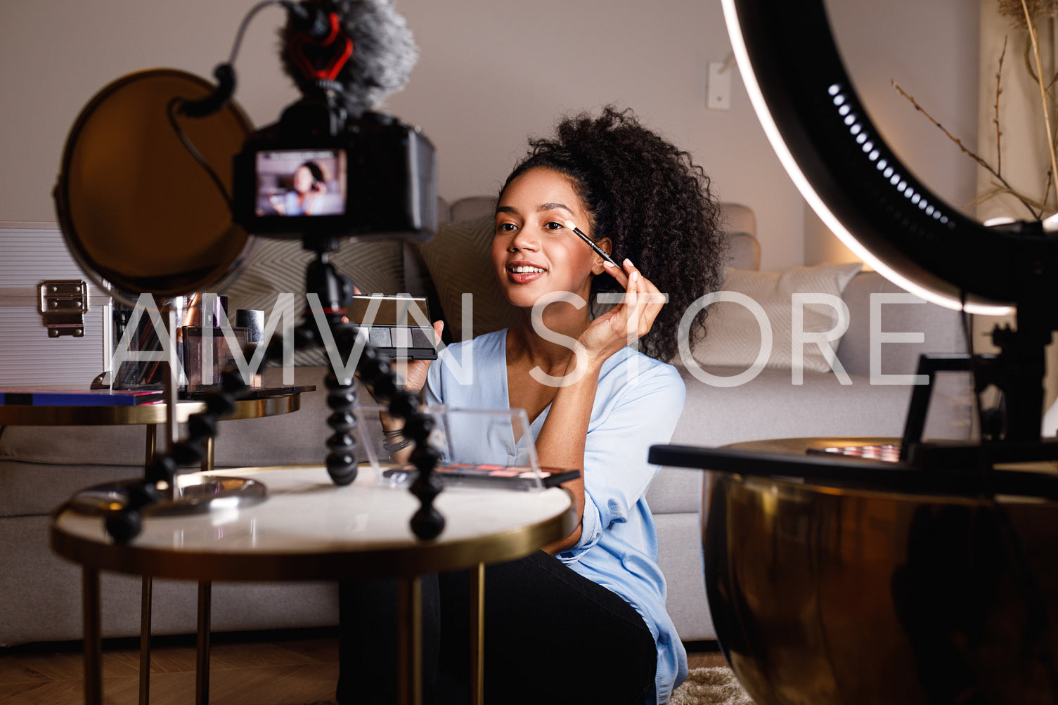 Beauty vlogger applying cosmetics on eyes in home	