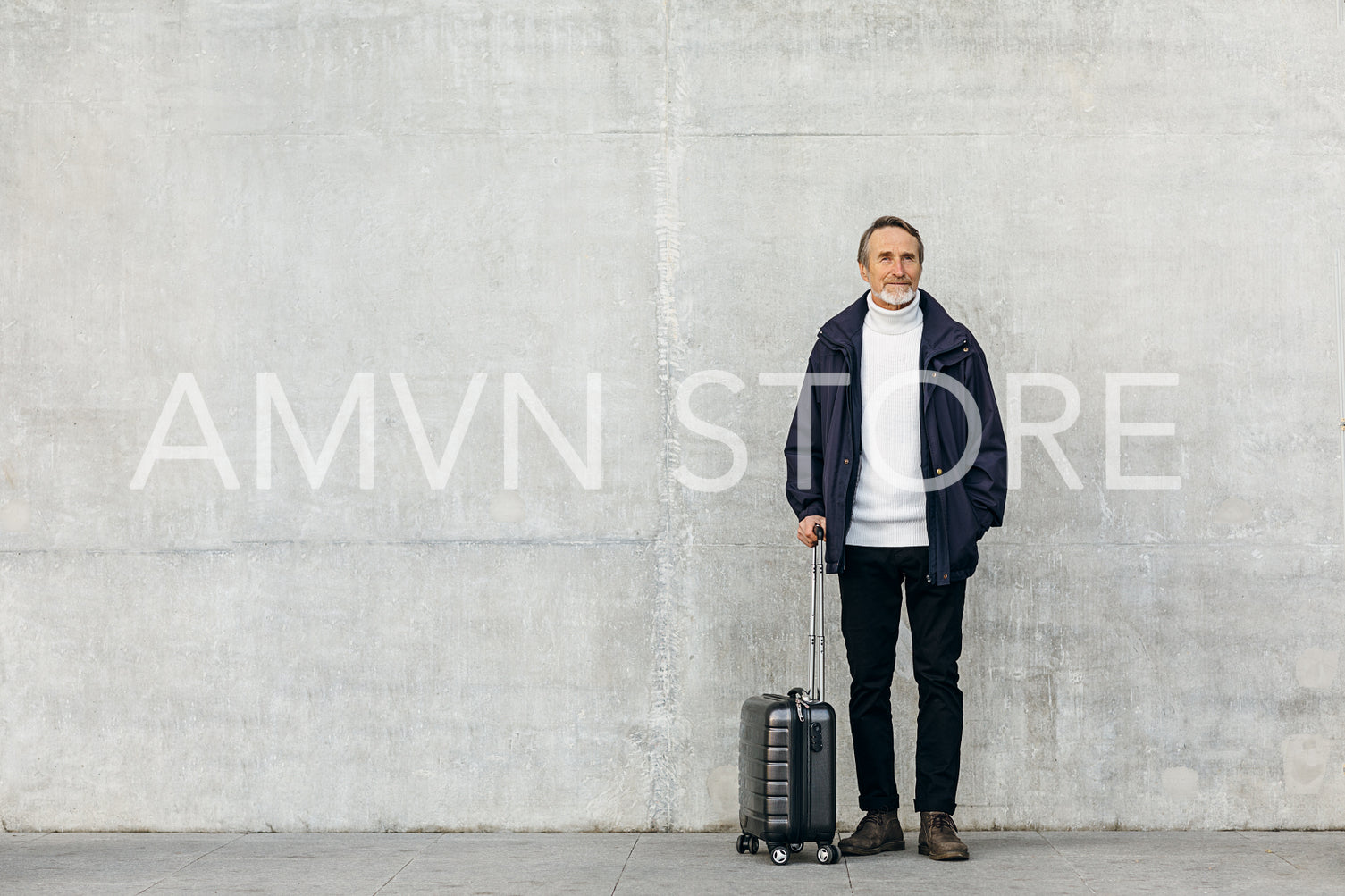 Senior tourist standing at wall with suitcase	