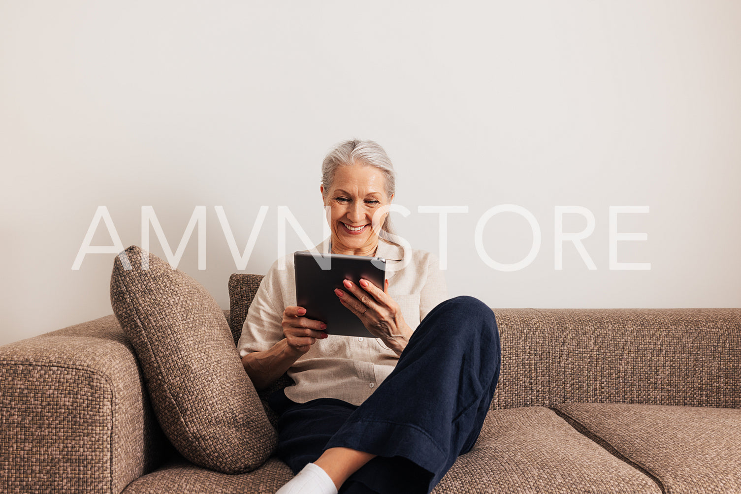 Adult cheerful female sitting on a sofa