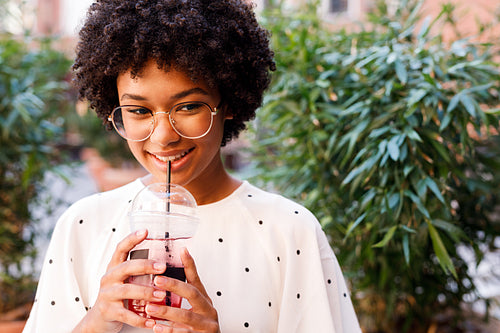 Portrait of a beautiful girl drinking juice with a straw