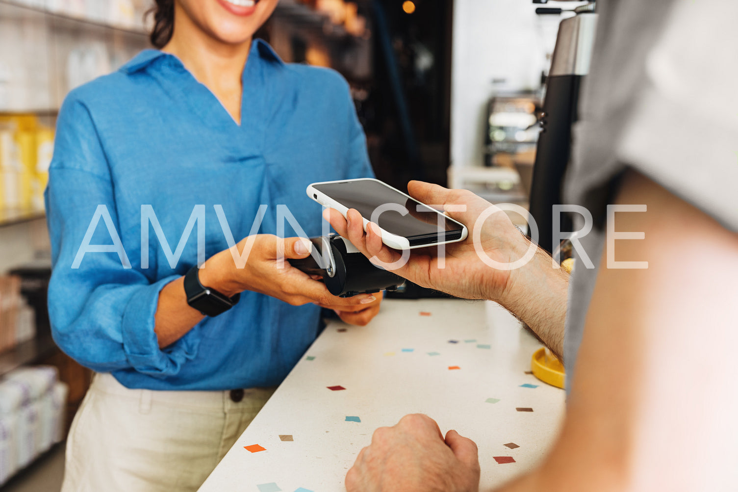 Customer paying bill through a smartphone using NFC technology	