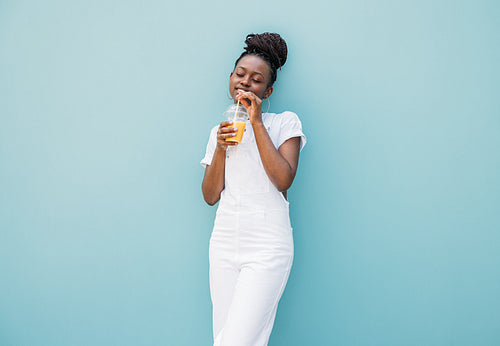 Young woman drinking orange juice