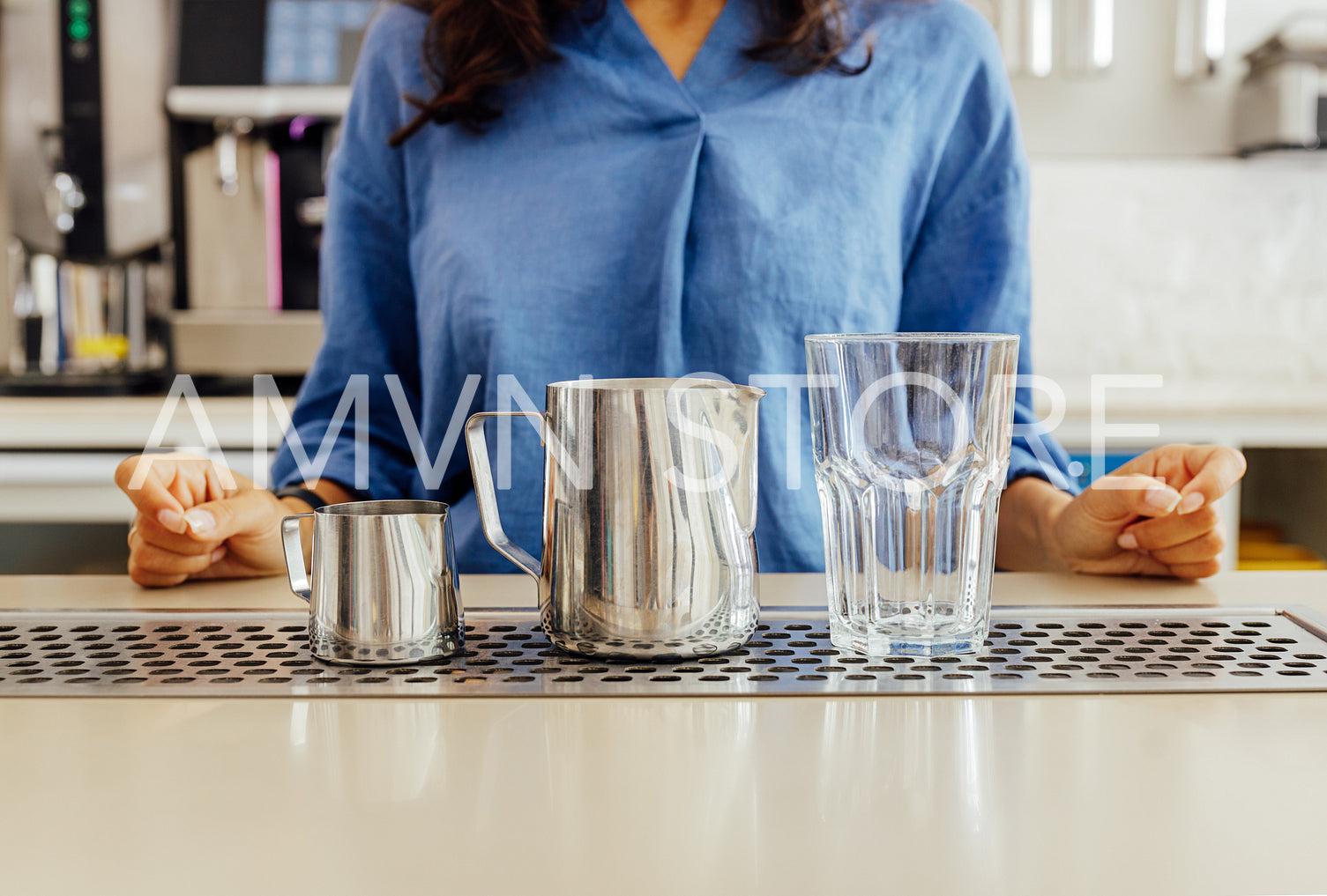 Shot of an unrecognizable female barista preparing for making latte	