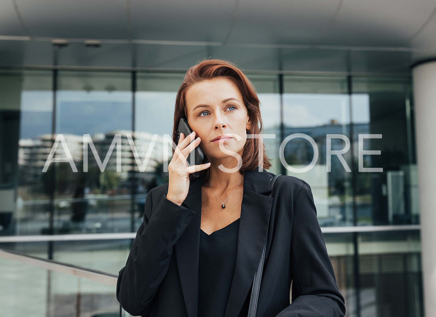 Portrait of a middle-aged female with ginger hair making a phone call