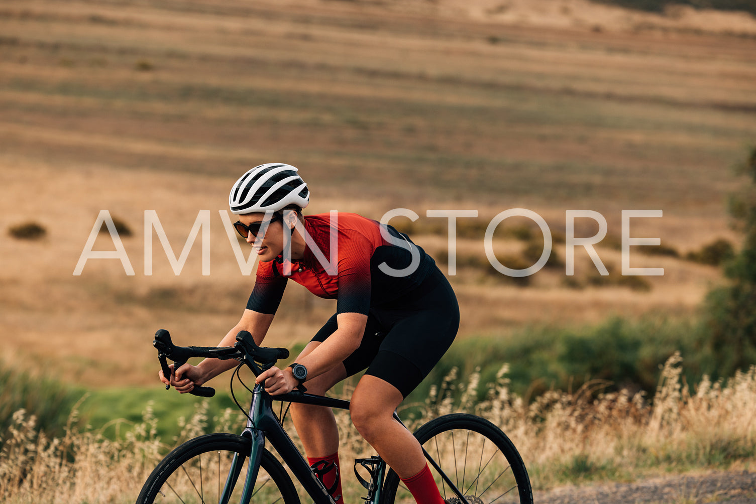 Sportswoman riding a bicycle on a country road. Professional cyclist practicing outdoors.