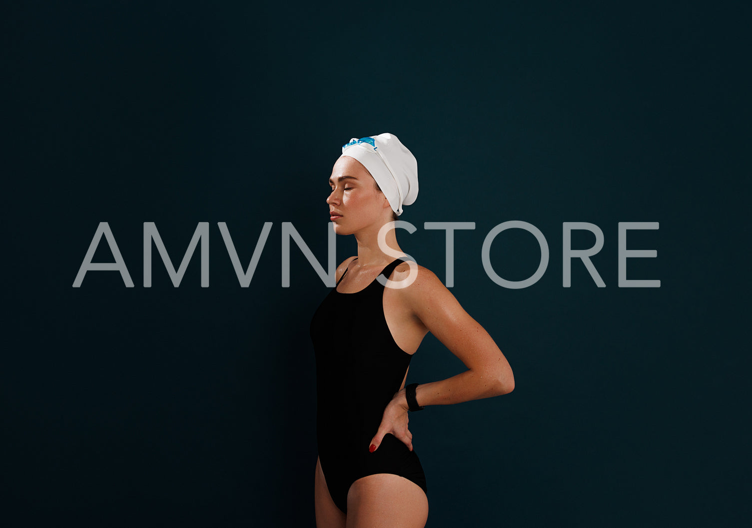 Young female swimmer with closed eyes and hands on hips relaxing over blue background