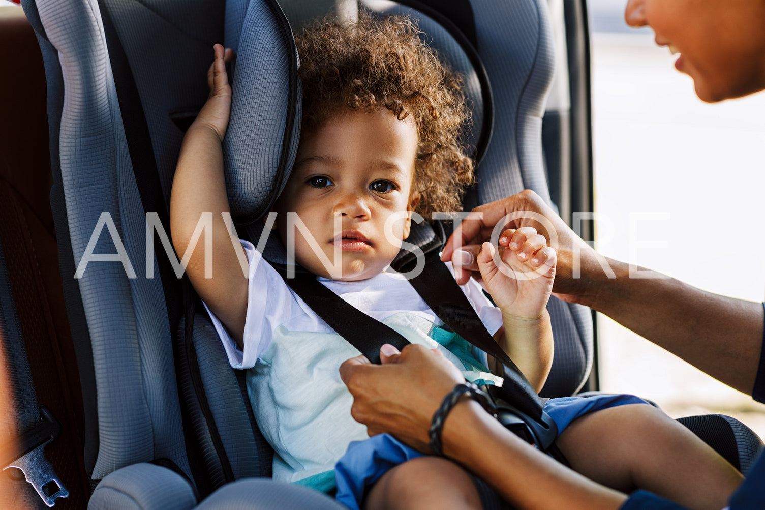 Portrait of a cute boy sitting in a baby seat	