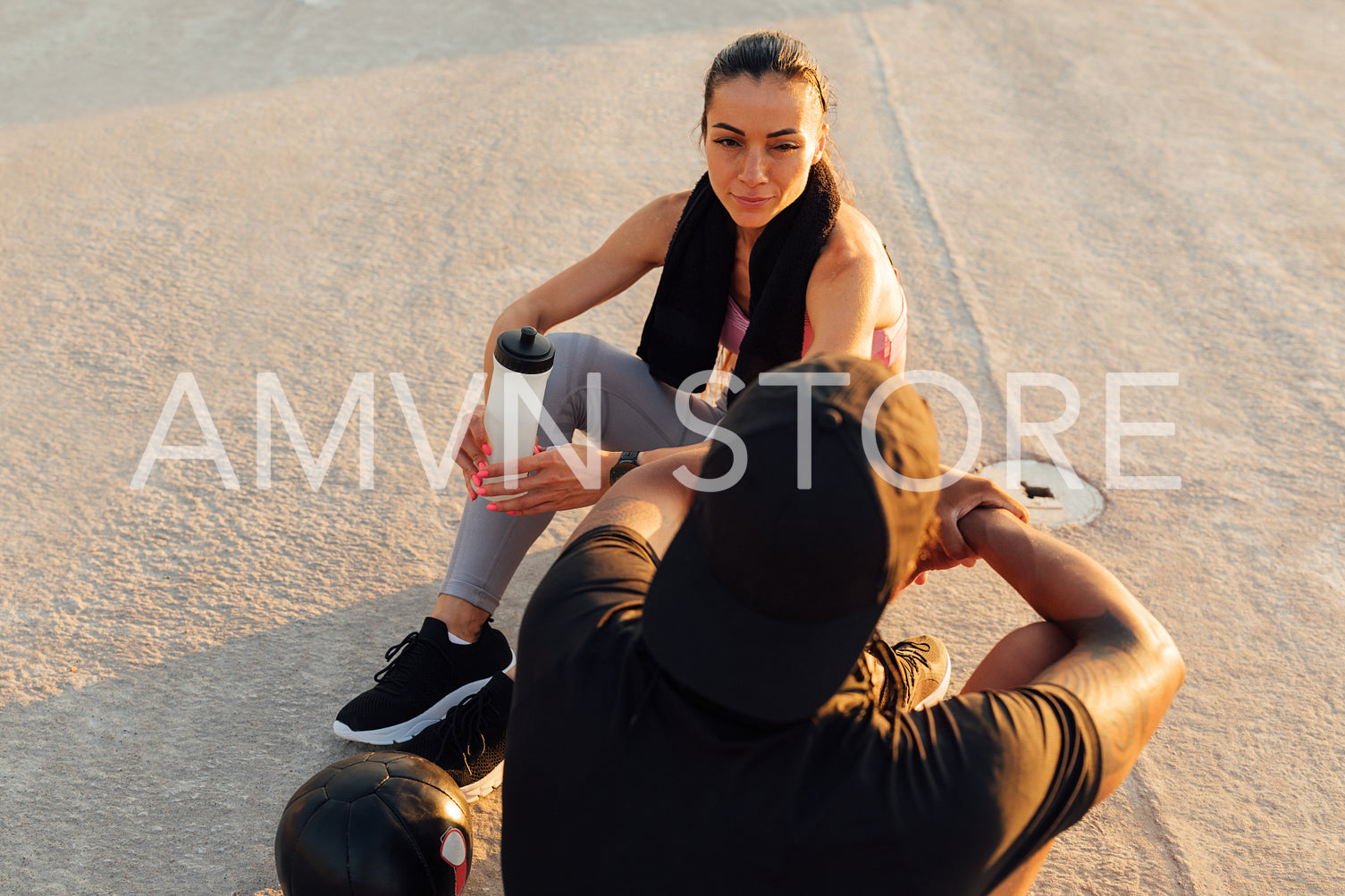 Fitness couple relaxing after training on a rooftop