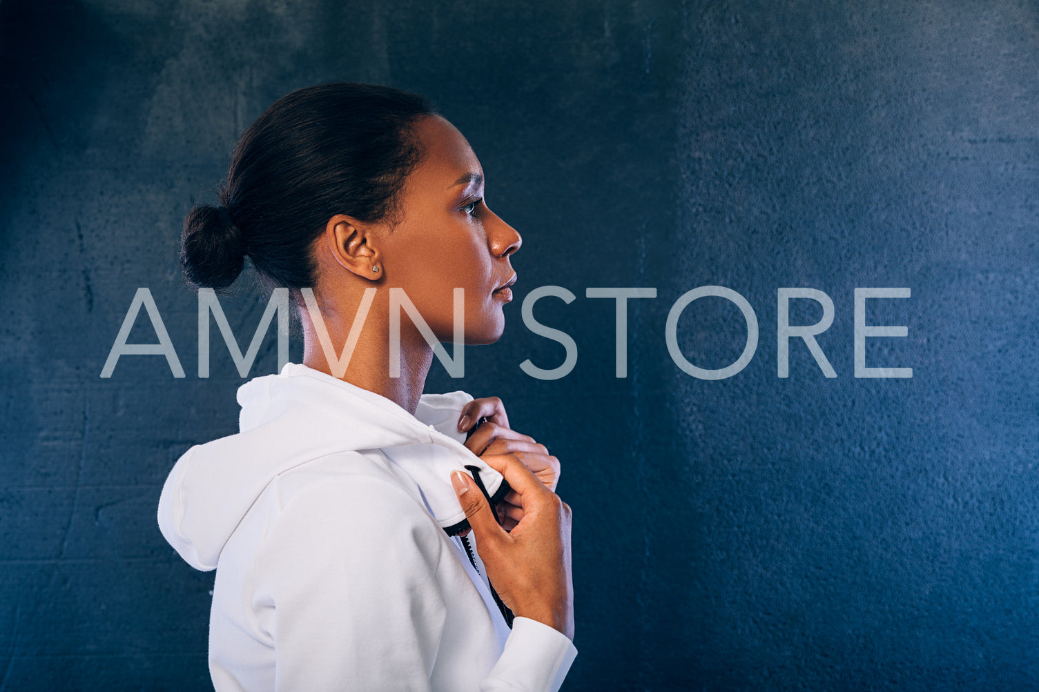 Side view of sporty woman wearing a sport clothes and looking away against black background