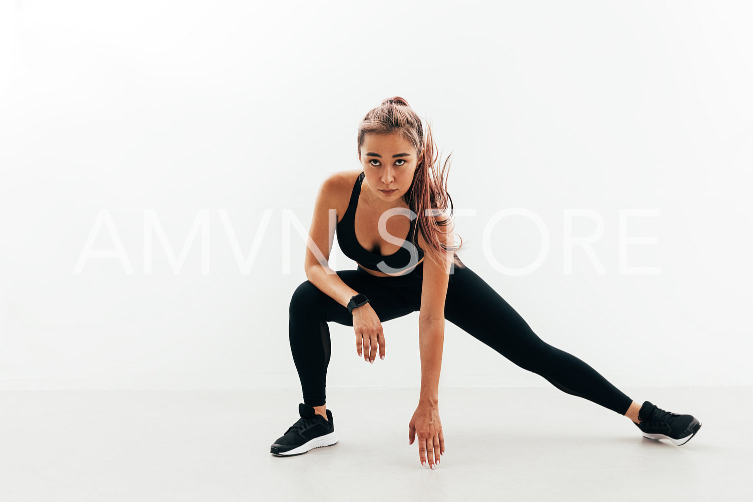 Young healthy woman stretching her body during fitness training