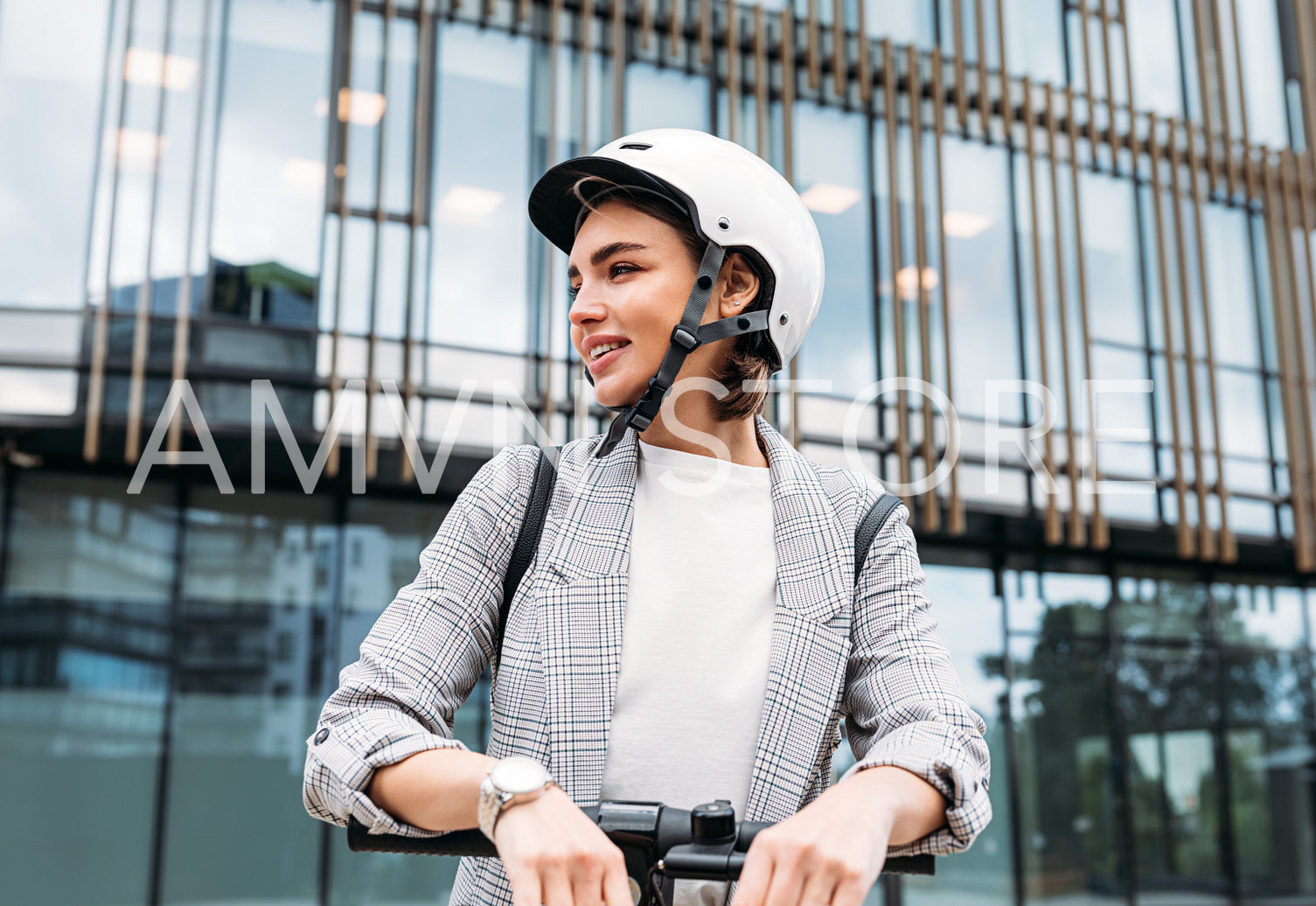 Portrait of a confident businesswoman in safety helmet standing outdoors with electric scooter