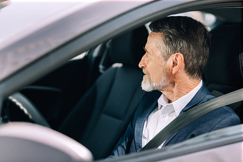 Side view of a bearded driver looking away