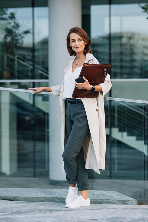 Full length of a stylish middle aged business woman standing outdoors