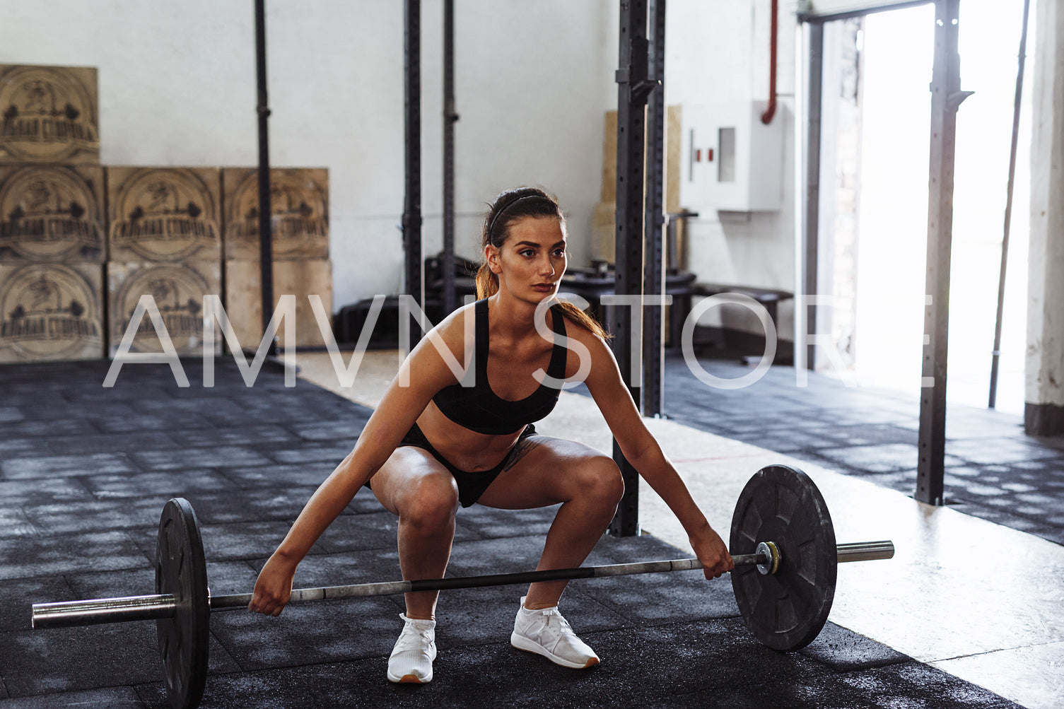 Female athlete prepairing for deadlifting in gym