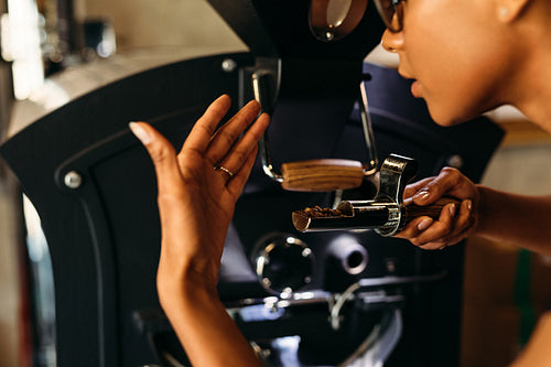 Close up shot of barista smelling a fresh roasted coffee